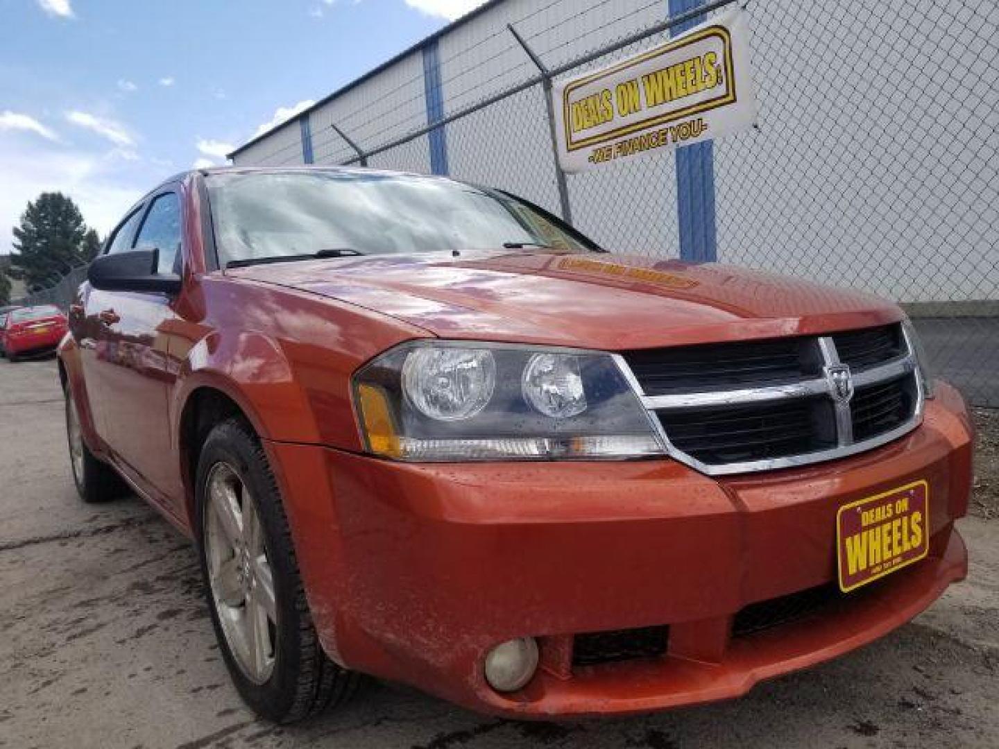 2008 Sunburst Orange Pear Dodge Avenger SXT (1B3LC56R08N) with an 2.7L V6 DOHC 24V FFV engine, 4-Speed Automatic transmission, located at 601 E. Idaho St., Kalispell, MT, 59901, 0.000000, 0.000000 - Photo#2