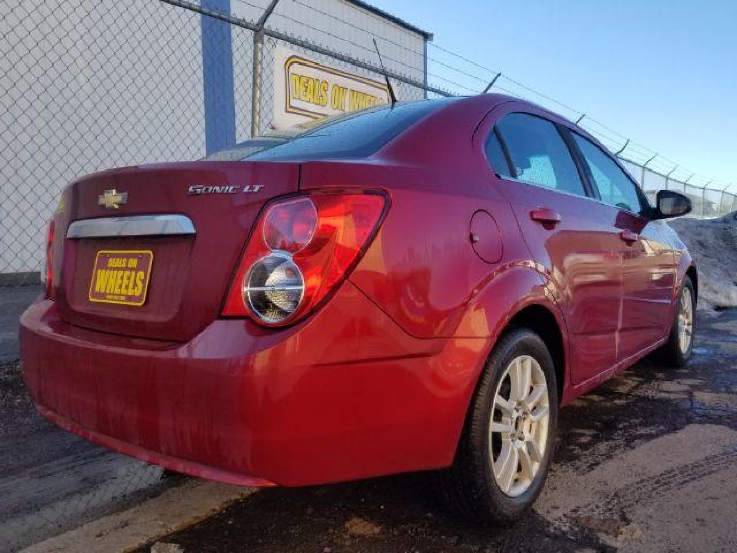 2012 Victory Red Chevrolet Sonic 2LT Sedan (1G1JC5SH9C4) with an 1.8L L4 DOHC 24V engine, 6-Speed Automatic transmission, located at 1821 N Montana Ave., Helena, MT, 59601, 0.000000, 0.000000 - Photo#4